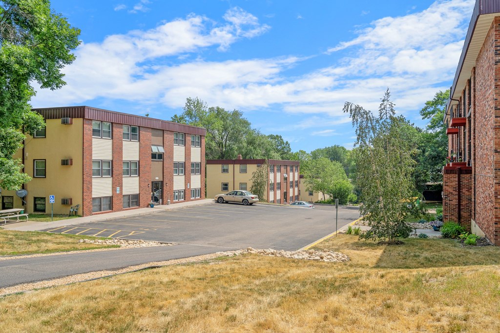 a city street with brick buildings and a parking lot