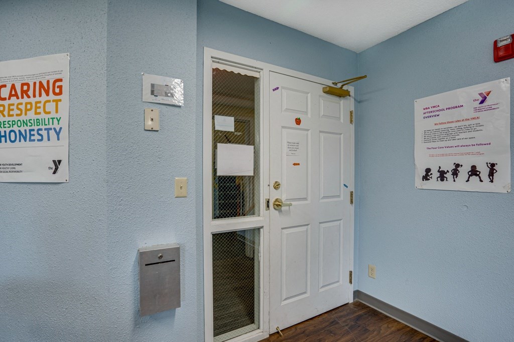 a room with a white door and a sign on the wall