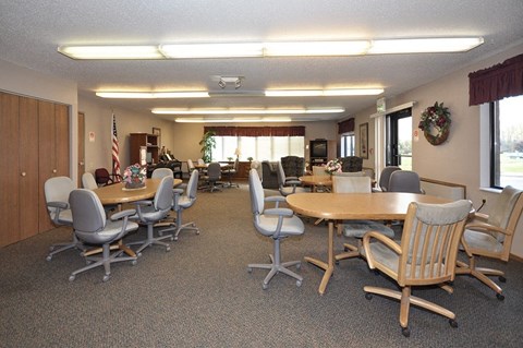 A conference room with a long table and chairs.