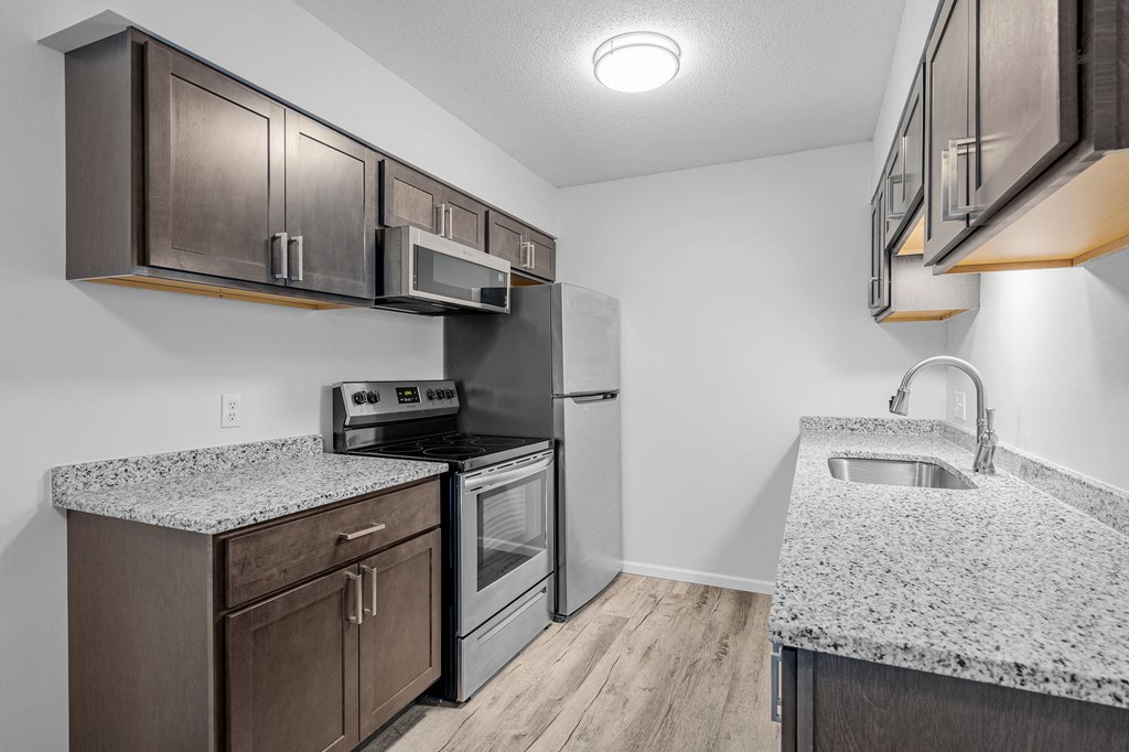 a kitchen with granite counter tops and stainless steel appliances