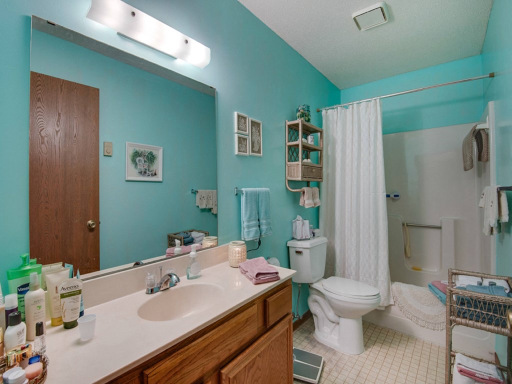 a bathroom with a toilet and a sink and a mirror
