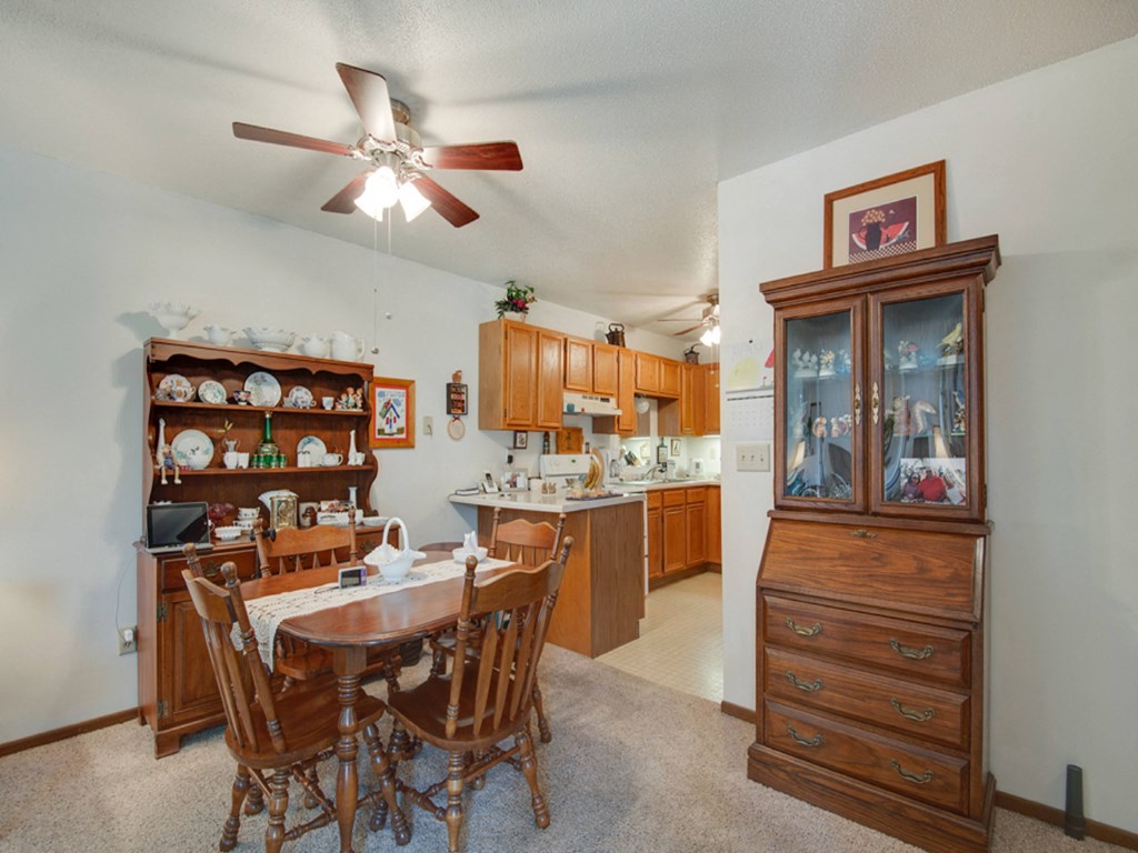 a dining room with a table and chairs and a kitchen