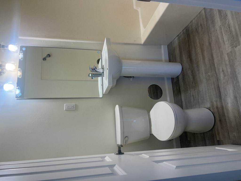 a small bathroom with a sink and toilet and a mirror