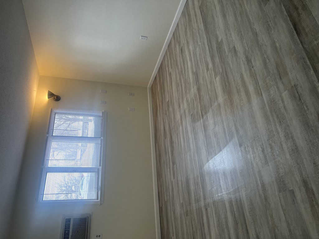 an empty room with a window and a wall