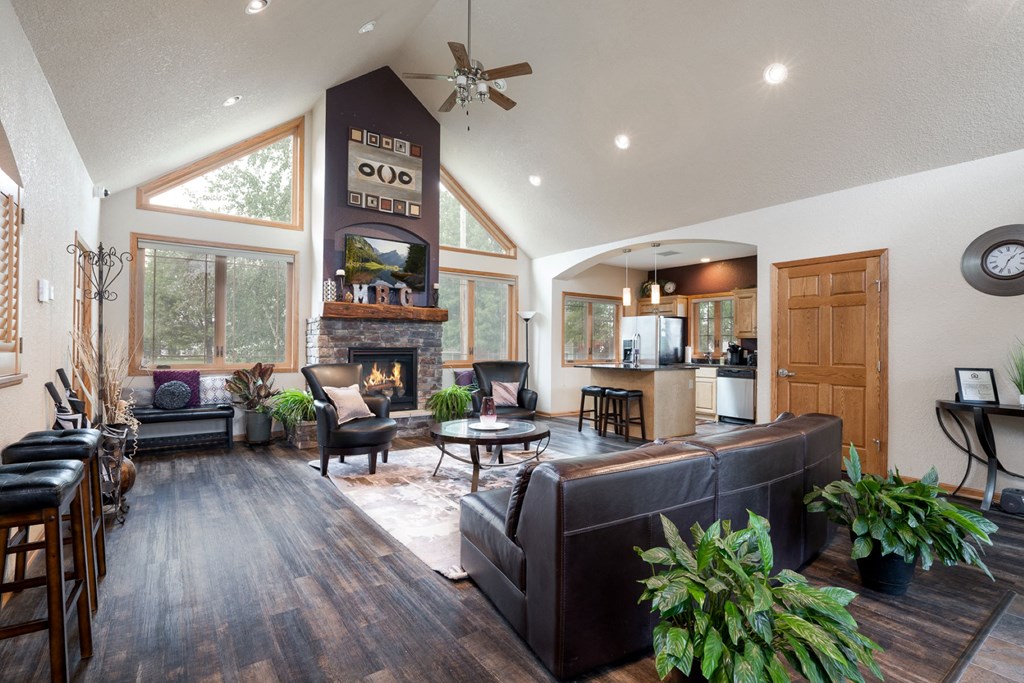 the view of a living room with couches and a fireplace