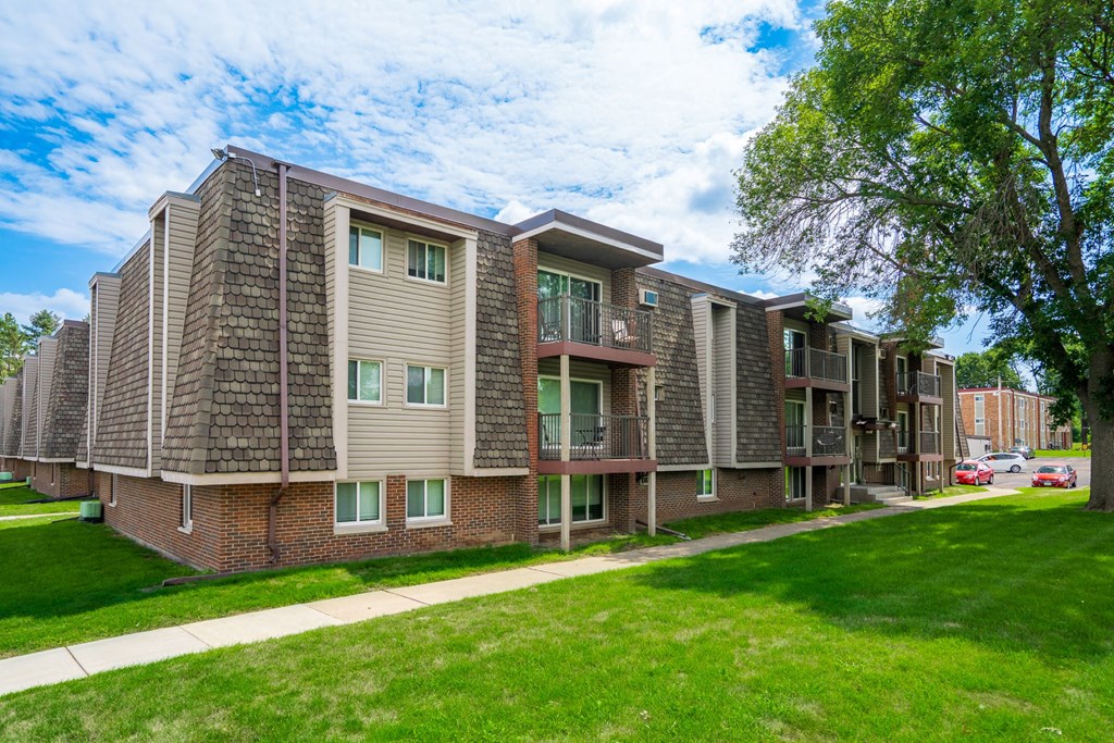 our apartments offer a spacious living area and a green lawn