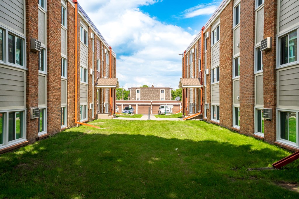 a view of a courtyard in front of a brick building