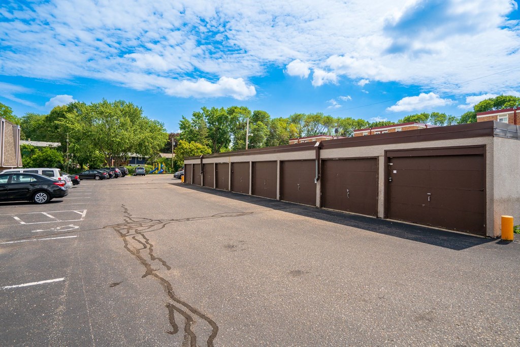 a large parking lot with cars parked in front of a building