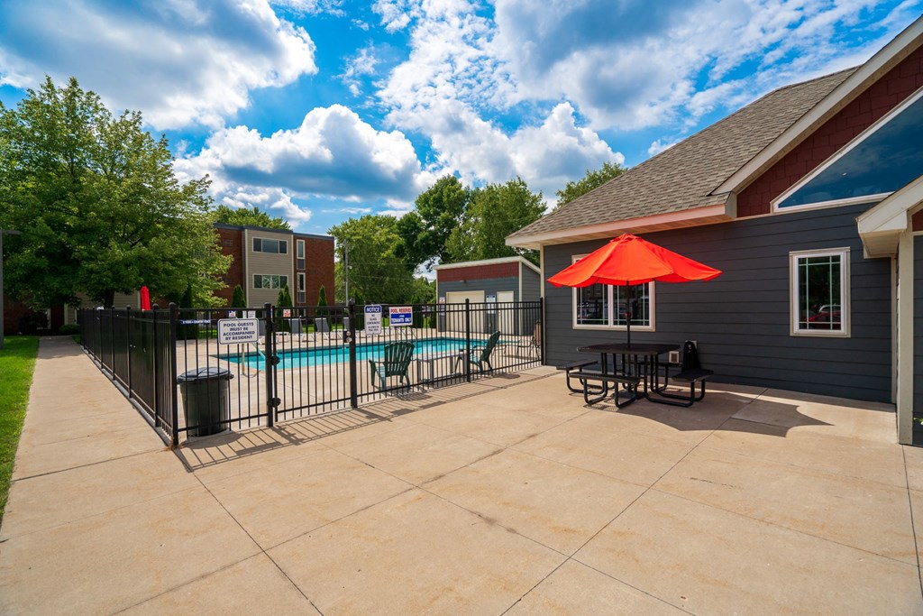 our apartments have a large patio with a pool and table