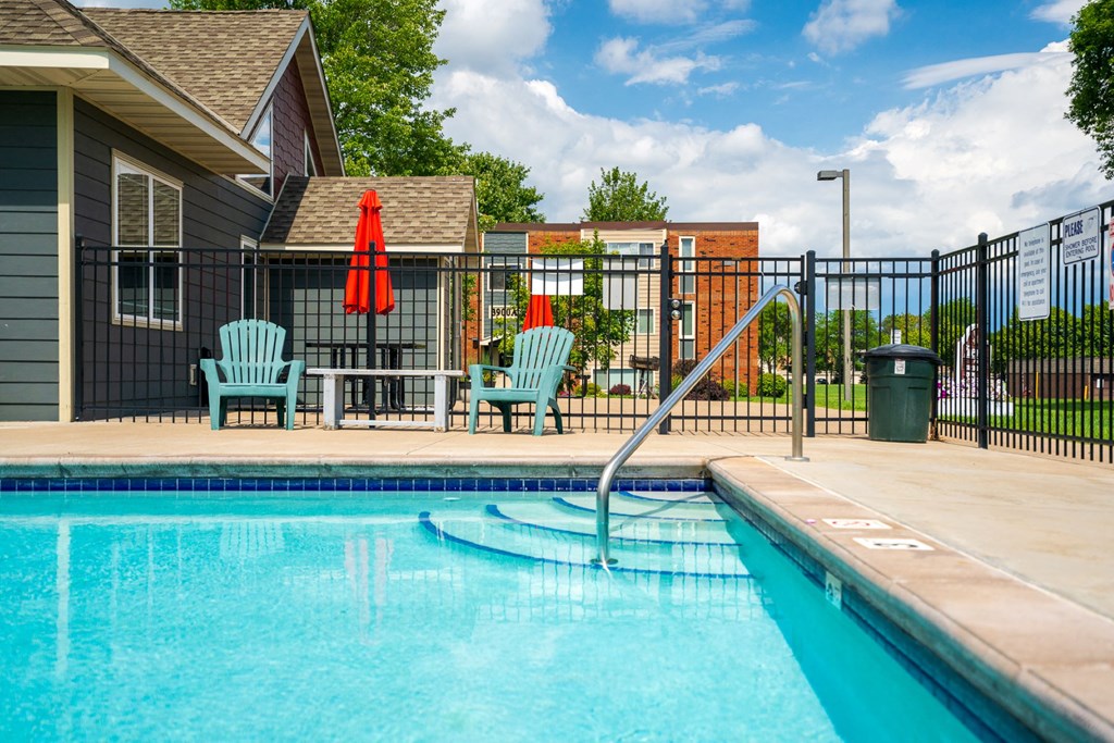 our apartments have a swimming pool and a patio with chairs