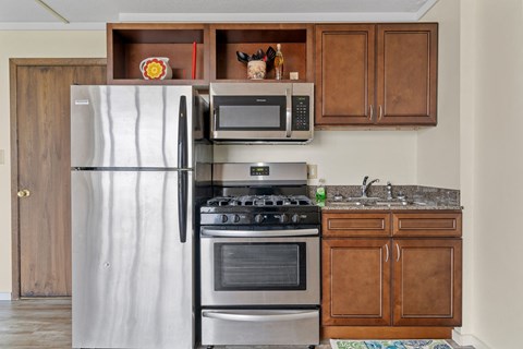 a kitchen with stainless steel appliances and wooden cabinets