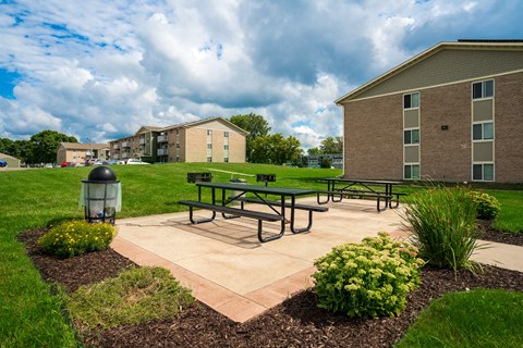 our apartments have a patio with benches and a fire hydrant