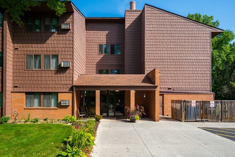 a large brick building with a sidewalk in front of it