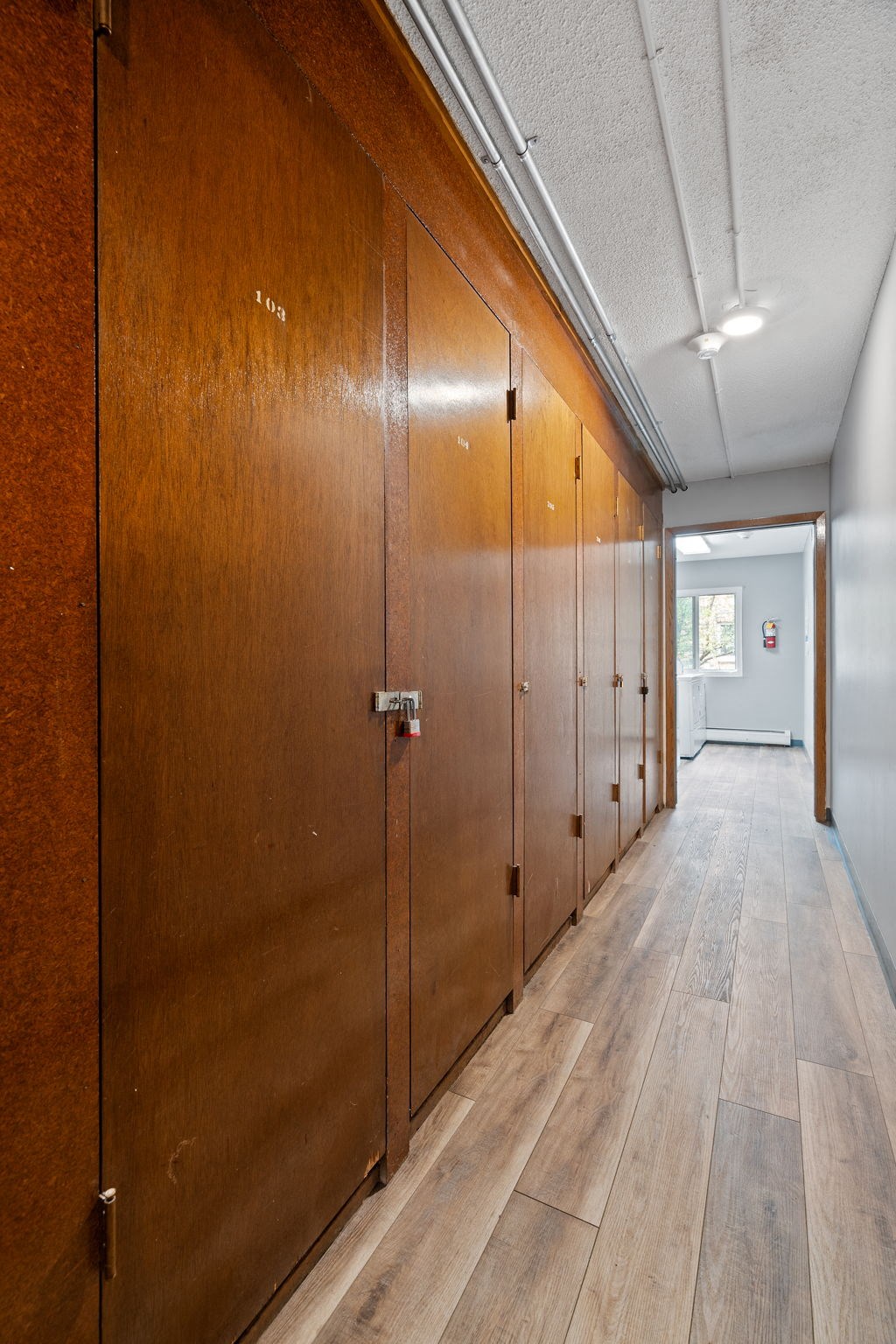 a row of wooden lockers in a hallway of a building