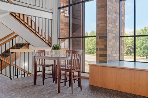 a dining room with a table and chairs and a large window