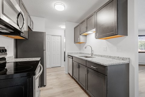 a kitchen with stainless steel appliances and granite counter tops