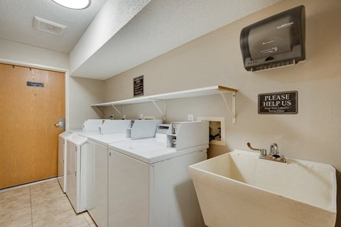 the laundry room is equipped with washer and dryer and a television