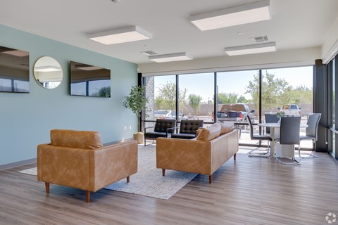 A living room with two couches and a large window.