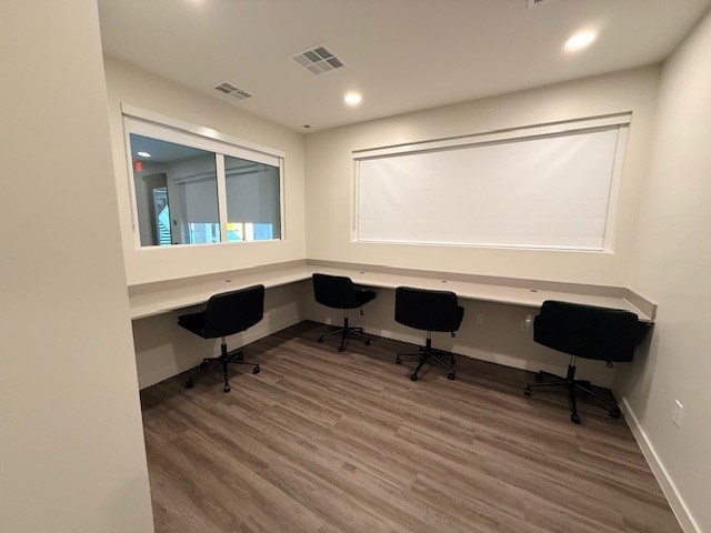 Shared computer workspace at Revive 25 Apartments.