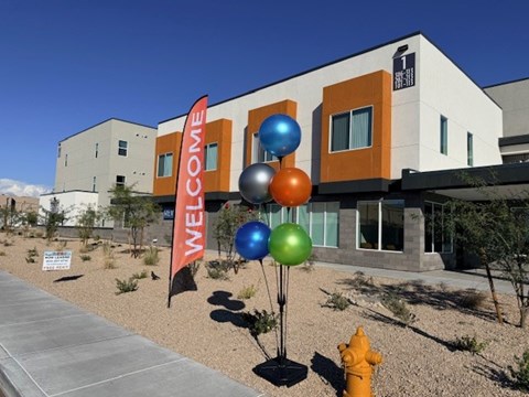 A building with a sign that says "Welcome" in front of it.