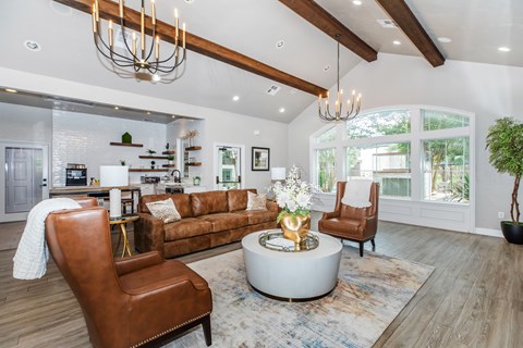 A modern living room with a brown leather chair and a white coffee table.