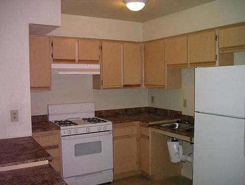 a kitchen with a stove and a refrigerator