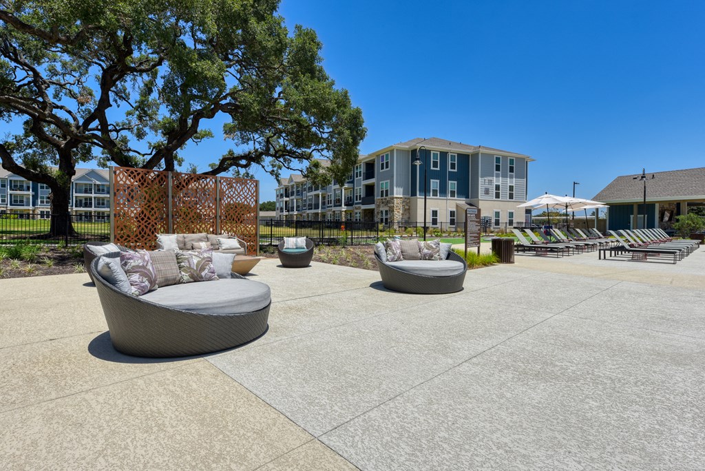 a seating area with couches and chairs in front of a building at Estraya Boerne, Boerne, TX