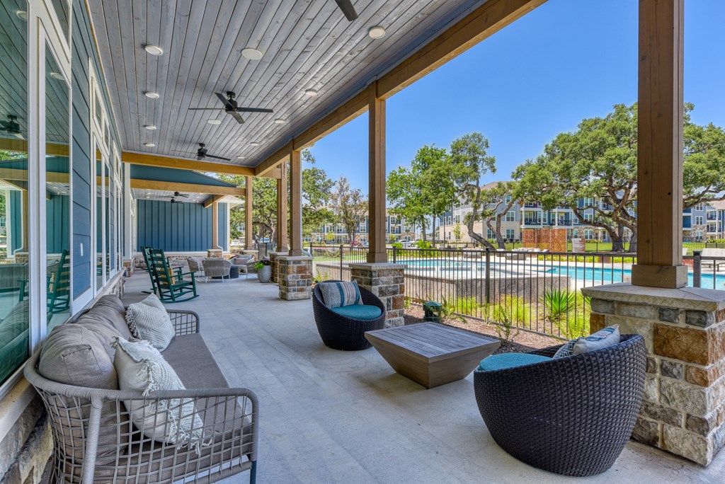 the preserve at ballantyne commons covered patio with furniture and a pool at Estraya Boerne, Texas, 78006
