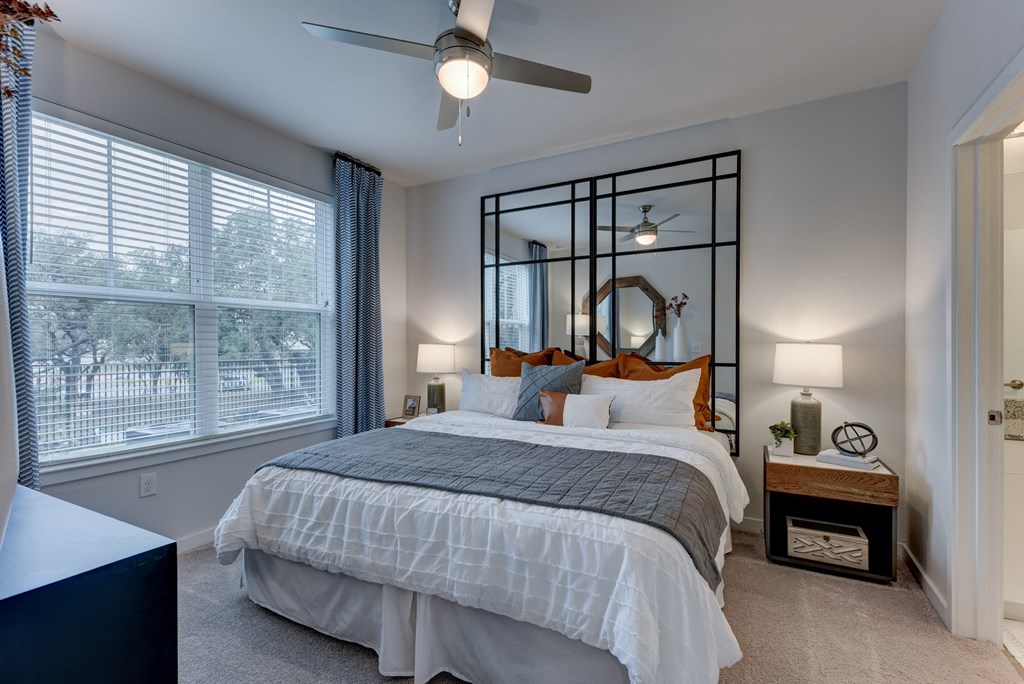 create a bedroom that is spacious and cozy with a large bed and a ceiling fan at Estraya Boerne, Texas, 78006
