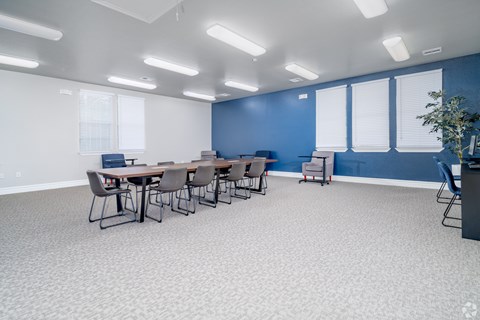 A conference room with a long table and chairs.