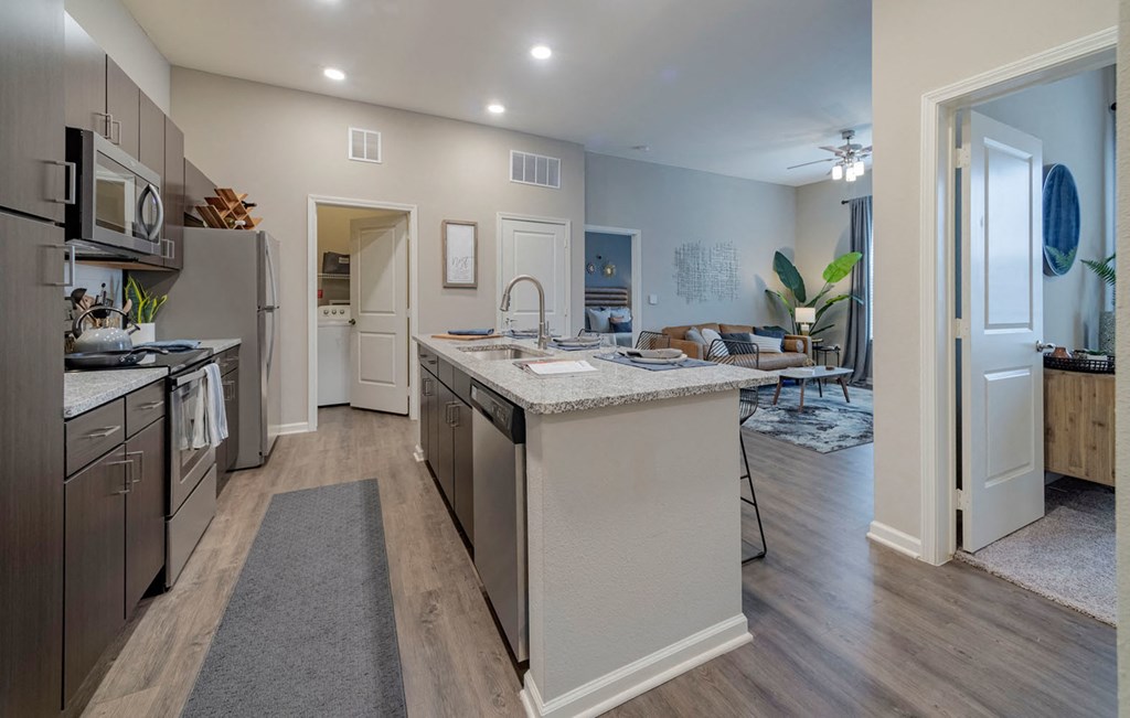 Kitchen with wooden cabinets and appliances at Seleno at Bridge Street, Alabama
