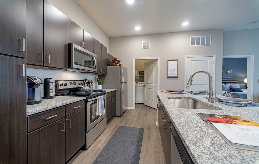 Kitchen with wooden cabinets at Seleno at Bridge Street, Huntsville, Alabama
