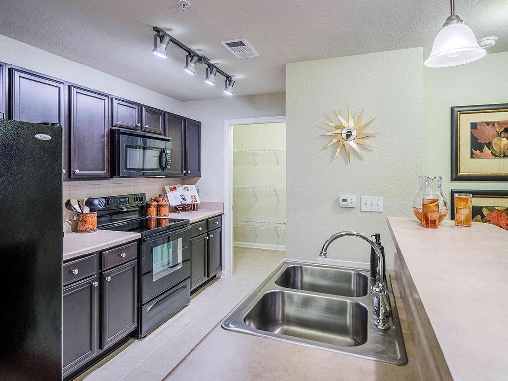 a kitchen with stainless steel appliances and a sink