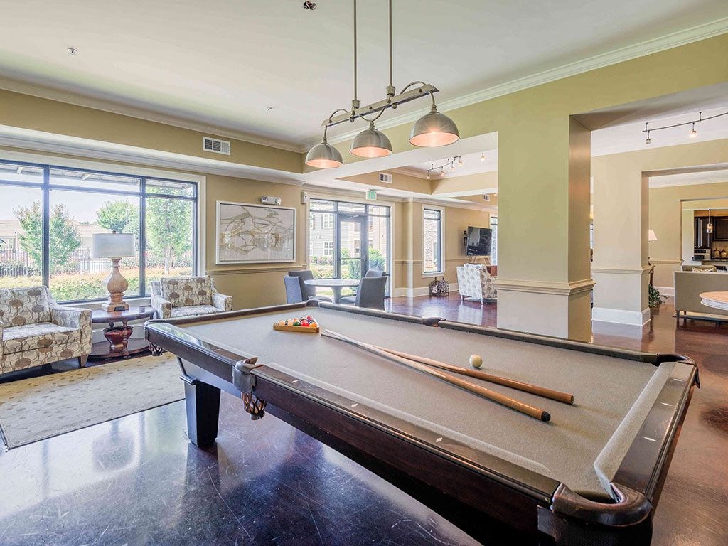 a pool table in the center of a living room