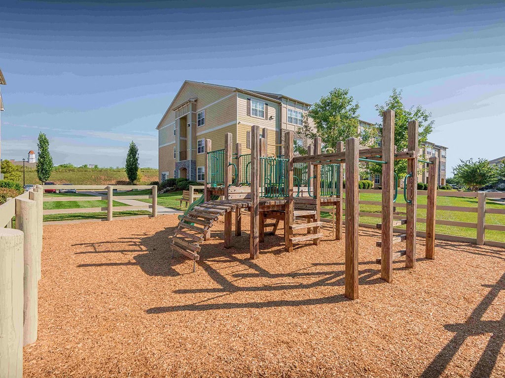 a playground with a building in the background