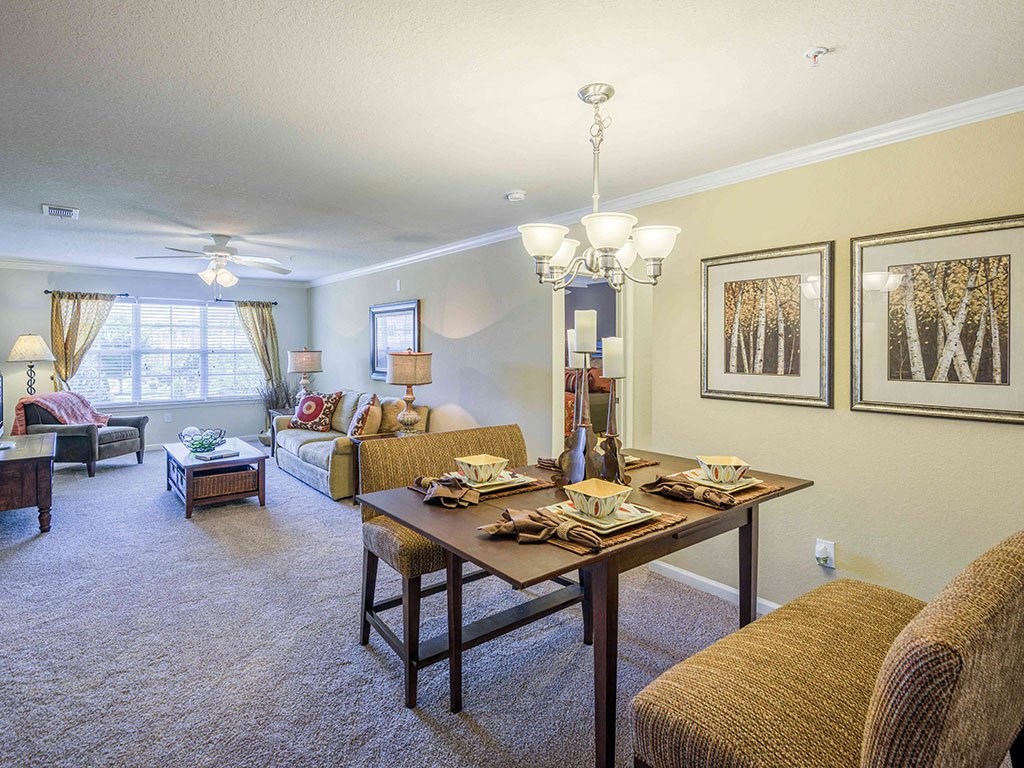 a living room and dining room with a table
