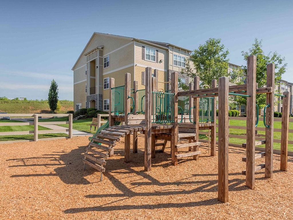 a playground with a house in the background