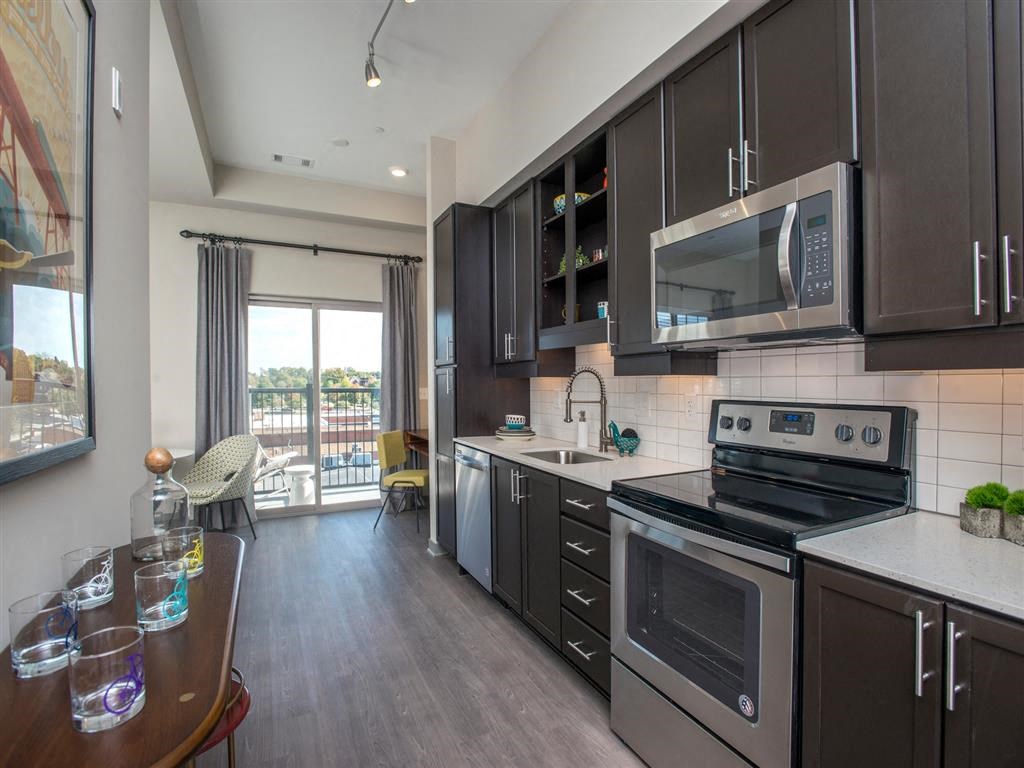 a kitchen with stainless steel appliances and a wooden table