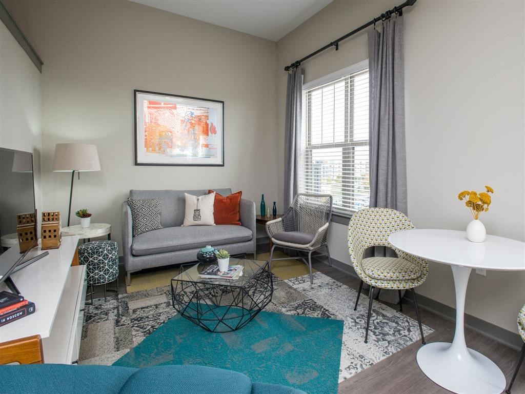 a living room with a couch and chairs and a table