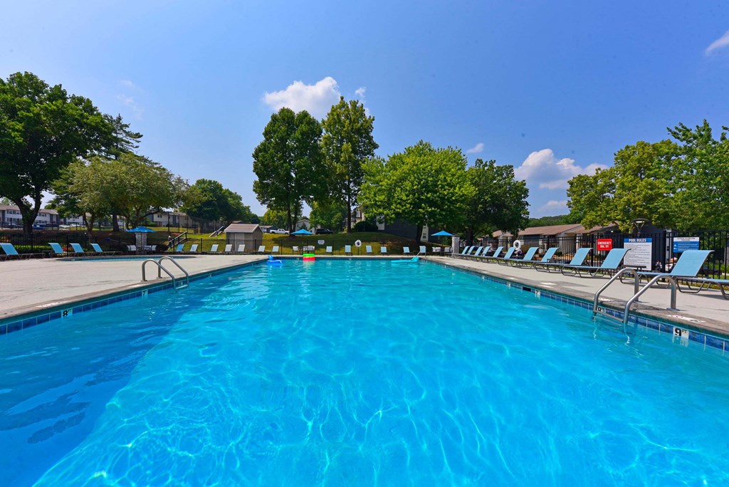 A large blue swimming pool with lounge chairs around it.at Addison at Sutherland, Tennessee  