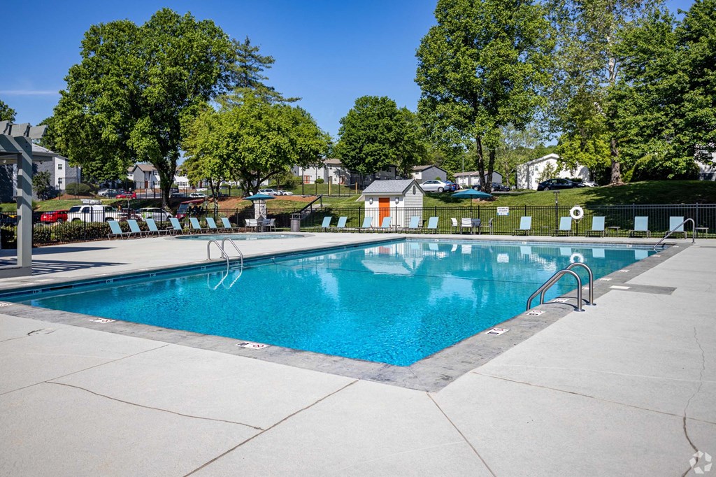 A large swimming pool surrounded by trees and a fence.at Addison at Sutherland, Tennessee  