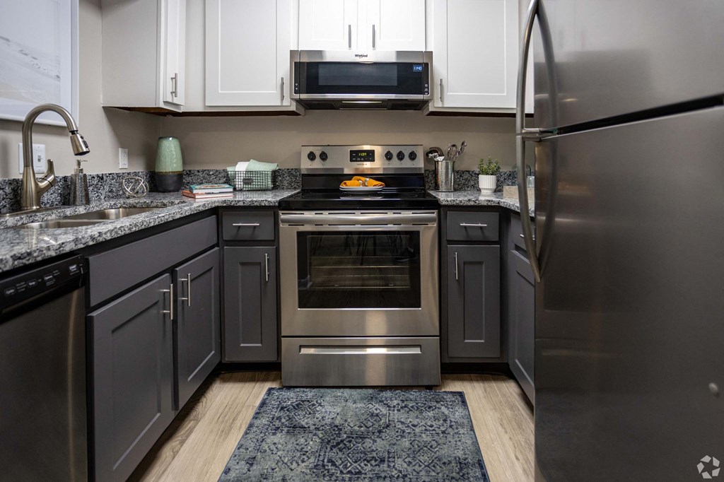A modern kitchen with a stainless steel refrigerator and oven.at Addison at Sutherland, Knoxville, TN  