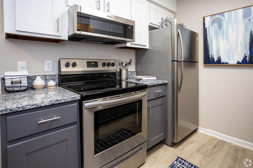 A modern kitchen with a stainless steel refrigerator, oven, and microwave.at Addison at Sutherland, Tennessee, 37909