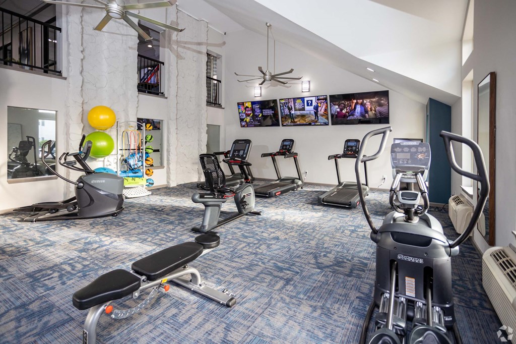 A gym with exercise equipment and a fan.at Addison at Sutherland, Knoxville, TN 37909  
