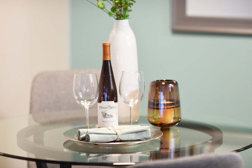 A bottle of wine and a glass are on a table.at Addison at Sutherland, Knoxville  