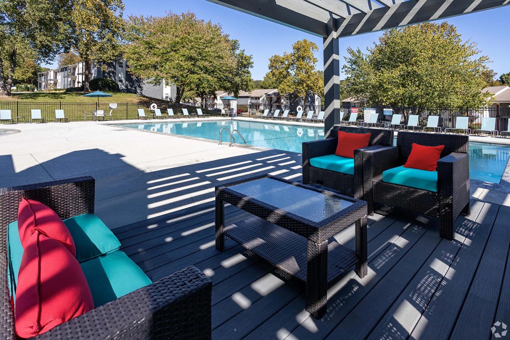 A poolside area with two black wicker chairs and a table.at Addison at Sutherland, Tennessee, 37909