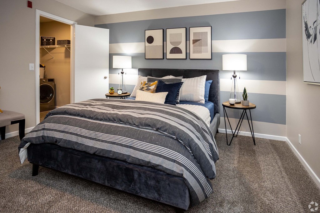 A bedroom with a large bed and two nightstands with lamps.at Addison at Sutherland, Tennessee, 37909