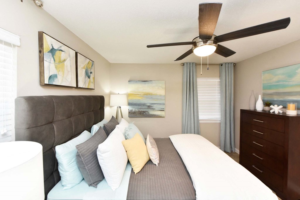 A bedroom with a bed, nightstand, and a ceiling fan.at Addison at Sutherland, Tennessee, 37909