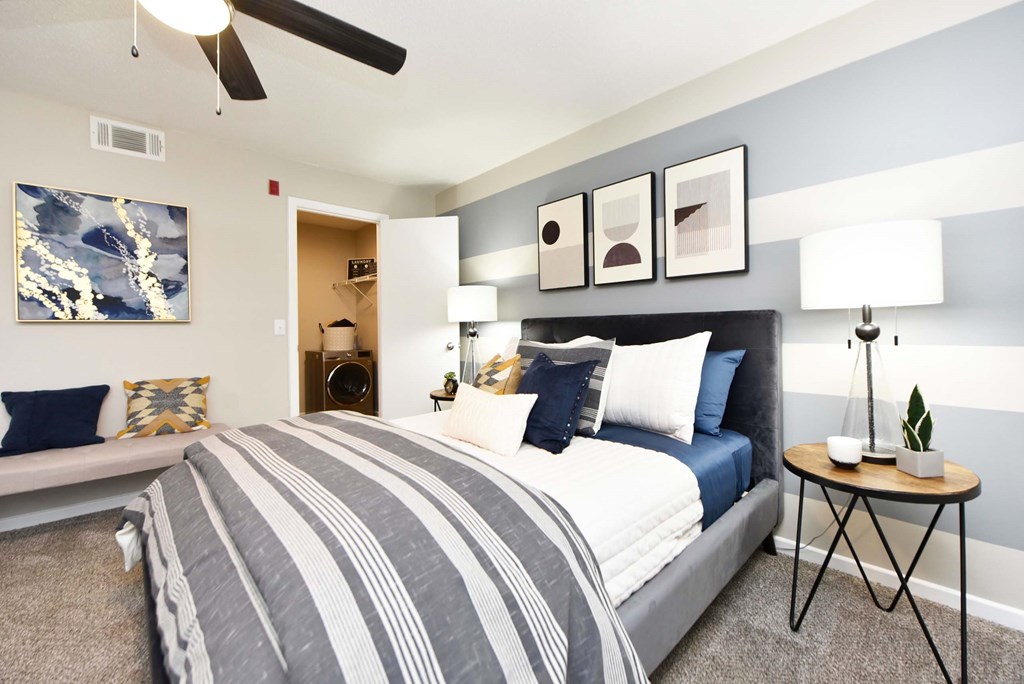 A bedroom with a large bed and a ceiling fan.at Addison at Sutherland, Knoxville  