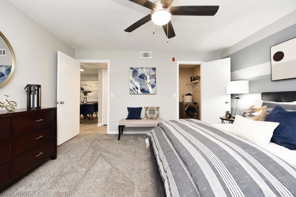 A bedroom with a large bed and a ceiling fan.at Addison at Sutherland, Knoxville Tennessee  